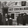 Farmers getting their checks in warehouse office after their tobacco has been sold at auction. Durham, North Carolina