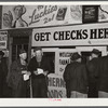 Farmers getting their checks in warehouse office after their tobacco has been sold at auction. Durham, North Carolina
