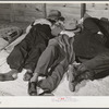 Farmers sleeping in white camp room in warehouse. They often must remain overnight or several days before their tobacco is auctioned. Durham, North Carolina