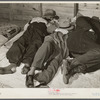 Farmers sleeping in white camp room in warehouse. They often must remain overnight or several days before their tobacco is auctioned. Durham, North Carolina