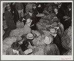 Auctioneer, buyers, and farmers during tobacco auction sale. Warehouse, Durham, North Carolina