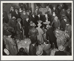 Auctioneer, buyers, and farmers during tobacco auction sale. Warehouse, Durham, North Carolina