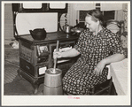 Mrs. Elvin Wilkins (Rosa) churning butter in the kitchen of their home in Tallyho. Near Stem, Granville County, North Carolina. See subregional notes (Odum) November 16, 1939