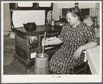 Mrs. Elvin Wilkins (Rosa) churning butter in the kitchen of their home in Tallyho. Near Stem, Granville County, North Carolina. See subregional notes (Odum) November 16, 1939