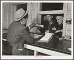 Farmers getting their checks in warehouse office after their tobacco has been sold at auction. Durham, North Carolina