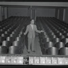 Publicity photograph of Fred Sears standing in the theatre of the Westchester County Playhouse