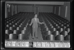 Publicity photograph of Fred Sears standing in the theatre of the Westchester County Playhouse