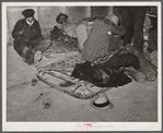 Farmers sleeping in [Black] camp room in warehouse. They often must remain overnight or several days before their tobacco is auctioned. One of them is using an old tobacco basket for a pillow. Durham, North Carolina