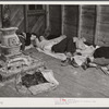 Farmers sleeping in white camp room in warehouse. They often must remain overnight or several days before their tobacco is auctioned. Durham, North Carolina