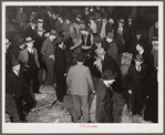 Auctioneer, buyers, and farmers during tobacco auction sale. Warehouse, Durham, North Carolina