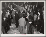 Auctioneer, buyers, and farmers during tobacco auction sale. Warehouse, Durham, North Carolina