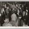 Auctioneer, buyers, and farmers during tobacco auction sale. Warehouse, Durham, North Carolina