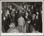 Auctioneer, buyers, and farmers during tobacco auction sale. Warehouse, Durham, North Carolina