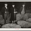 Farmer and his wife waiting for their tobacco to be sold at auction in warehouse. Durham, North Carolina