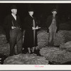 Farmer and his wife waiting for their tobacco to be sold at auction in warehouse. Durham, North Carolina