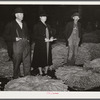 Farmer and his wife waiting for their tobacco to be sold at auction in warehouse. Durham, North Carolina