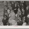 Tobacco auctioneer (in white gloves) and buyers during auction sale in warehouse in Mebane, Orange County, North Carolina