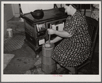 Mrs. Elvin Wilkins (Rosa) churning butter in the kitchen of their home in Tallyho, near Stem, Granville County, North Carolina. See subregional notes (Odum) November 16, 1939