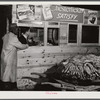 Weighing a basket of tobacco in warehouse before auction sale. Durham, North Carolina