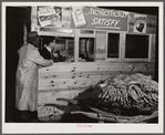 Weighing a basket of tobacco in warehouse before auction sale. Durham, North Carolina