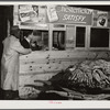 Weighing a basket of tobacco in warehouse before auction sale. Durham, North Carolina