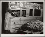 Weighing a basket of tobacco in warehouse before auction sale. Durham, North Carolina