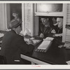 Farmers getting their checks in warehouse office after their tobacco has been sold at auction. Durham, North Carolina