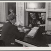 Farmers getting their checks in warehouse office after their tobacco has been sold at auction. Durham, North Carolina