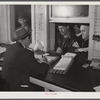 Farmers getting their checks in warehouse office after their tobacco has been sold at auction. Durham, North Carolina