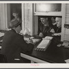 Farmers getting their checks in warehouse office after their tobacco has been sold at auction. Durham, North Carolina