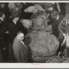 Auctioneer, buyers, and farmers during tobacco auction sale. Warehouse, Durham, North Carolina