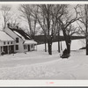 R.W. Cassidy farmer, Putney, Vermont, hauling manure with his sled and team. He owns about two hundred acres, has lived here about seventeen years