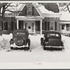 Every available space for parking is used by skiers on weekends at Clinton Gilbert's farm. The house is about 8 years old; purchased by Gilbert in 1929. He has about 150 acres, mainly a dairy farm with 23 cows. He also makes about 100 gallons of maple