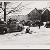 Every available space for parking is used by skiers on weekends at Clinton Gilbert's farm. The house is about 8 years old; purchased by Gilbert in 1929. He has about 150 acres, mainly a dairy farm with 23 cows. He also makes about 100 gallons of maple