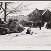 Every available space for parking is used by skiers on weekends at Clinton Gilbert's farm. The house is about 8 years old; purchased by Gilbert in 1929. He has about 150 acres, mainly a dairy farm with 23 cows. He also makes about 100 gallons of maple