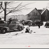 Every available space for parking is used by skiers on weekends at Clinton Gilbert's farm. The house is about 8 years old; purchased by Gilbert in 1929. He has about 150 acres, mainly a dairy farm with 23 cows. He also makes about 100 gallons of maple