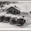 Every available space for parking is used by skiers on weekends at Clinton Gilbert's farm. The house is about 8 years old; purchased by Gilbert in 1929. He has about 150 acres, mainly a dairy farm with 23 cows. He also makes about 100 gallons of maple