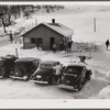 Every available space for parking is used by skiers on weekends at Clinton Gilbert's farm. The house is about 8 years old; purchased by Gilbert in 1929. He has about 150 acres, mainly a dairy farm with 23 cows. He also makes about 100 gallons of maple