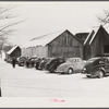 Every available space for parking is used by skiers on weekends at Clinton Gilbert's farm. The house is about 8 years old; purchased by Gilbert in 1929. He has about 150 acres, mainly a dairy farm with 23 cows. He also makes about 100 gallons of maple