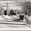 Sled and oxen hauling manure from barn to field. Rupert Lewis dairy farm. Woodstock, Vermont