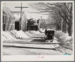 Sled and oxen hauling manure from barn to field. Rupert Lewis dairy farm. Woodstock, Vermont