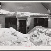 House in Woodstock, Vermont with drifts piled in front of windows and door