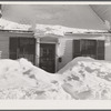 House in Woodstock, Vermont with drifts piled in front of windows and door