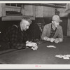 Farmers playing cards in pool room in town on a winter morning in Woodstock, Vermont