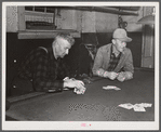 Farmers playing cards in pool room in town on a winter morning in Woodstock, Vermont