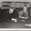 Farmers playing cards in pool room in town on a winter morning in Woodstock, Vermont