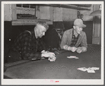 Farmers playing cards in pool room in town on a winter morning in Woodstock, Vermont