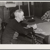 Proprietor of pool room and one of the townspeople playing cards on a winter morning. Woodstock, Vermont