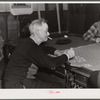 Proprietor of pool room and one of the townspeople playing cards on a winter morning. Woodstock, Vermont