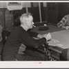 Proprietor of pool room and one of the townspeople playing cards on a winter morning. Woodstock, Vermont